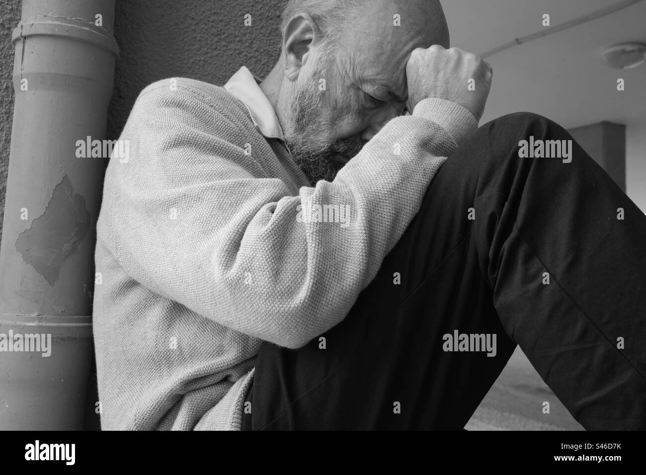 Monochrome scene of depressed senior man Stock Photo