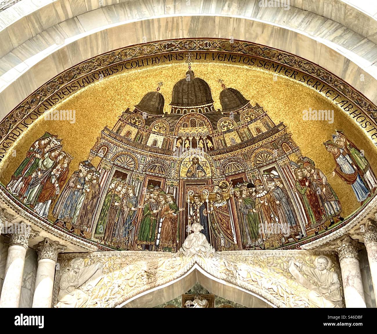 The top of a portal at St. Mark’s Basilica in Venice, depicting the  transition of Saint Mark’s body, in gilded mosaics - Smartphone Captured Stock Image