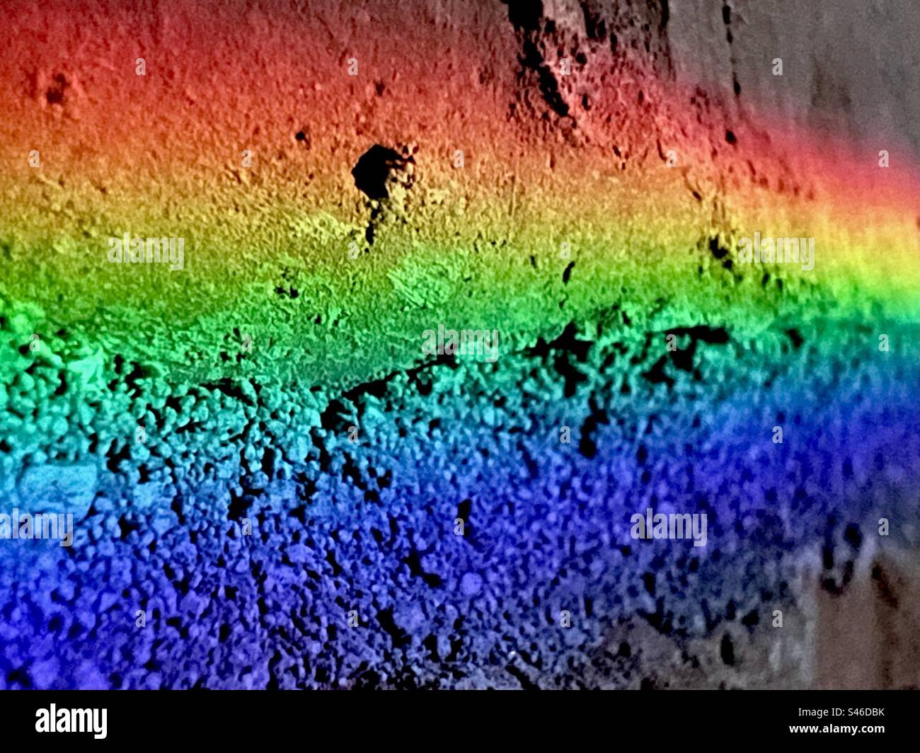 Rainbow colors on a brick wall Stock Photo