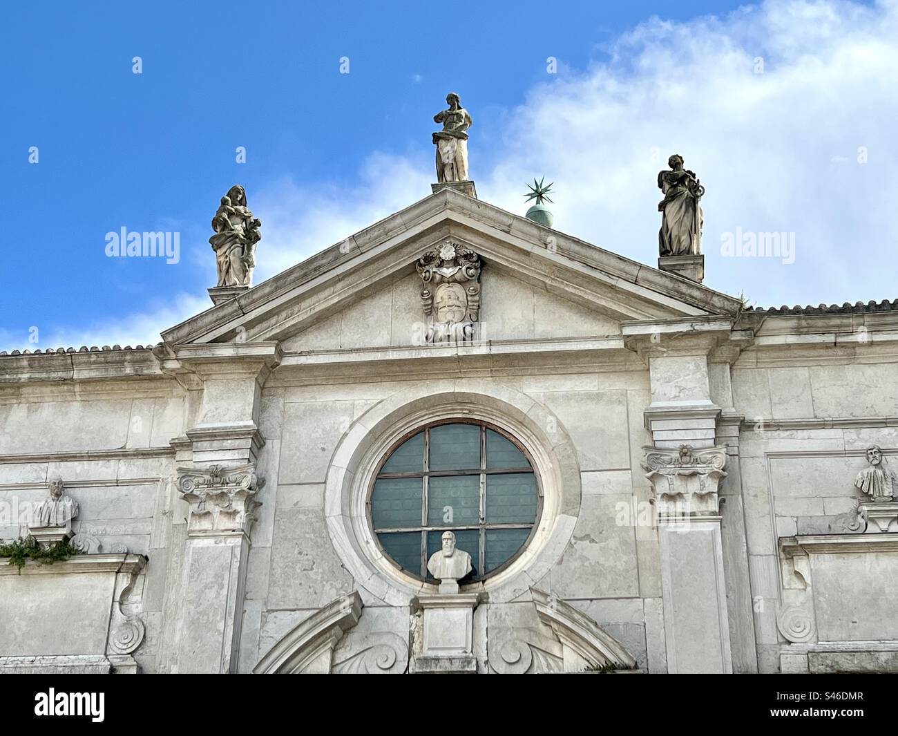 Statues adorn the roofline of the north facade of Chiesa Santa Maria Formosa in Castello, Venice - Smartphone Captured Stock Image