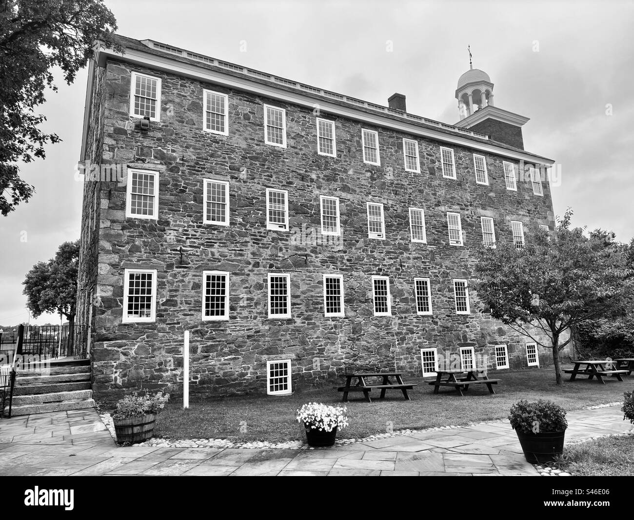Black and white of Old Slater Mill National Historic Landmark in Pawtucket, Rhode Island, USA. Stone building. First water powered textile mill in America. - Smartphone Captured Stock Image