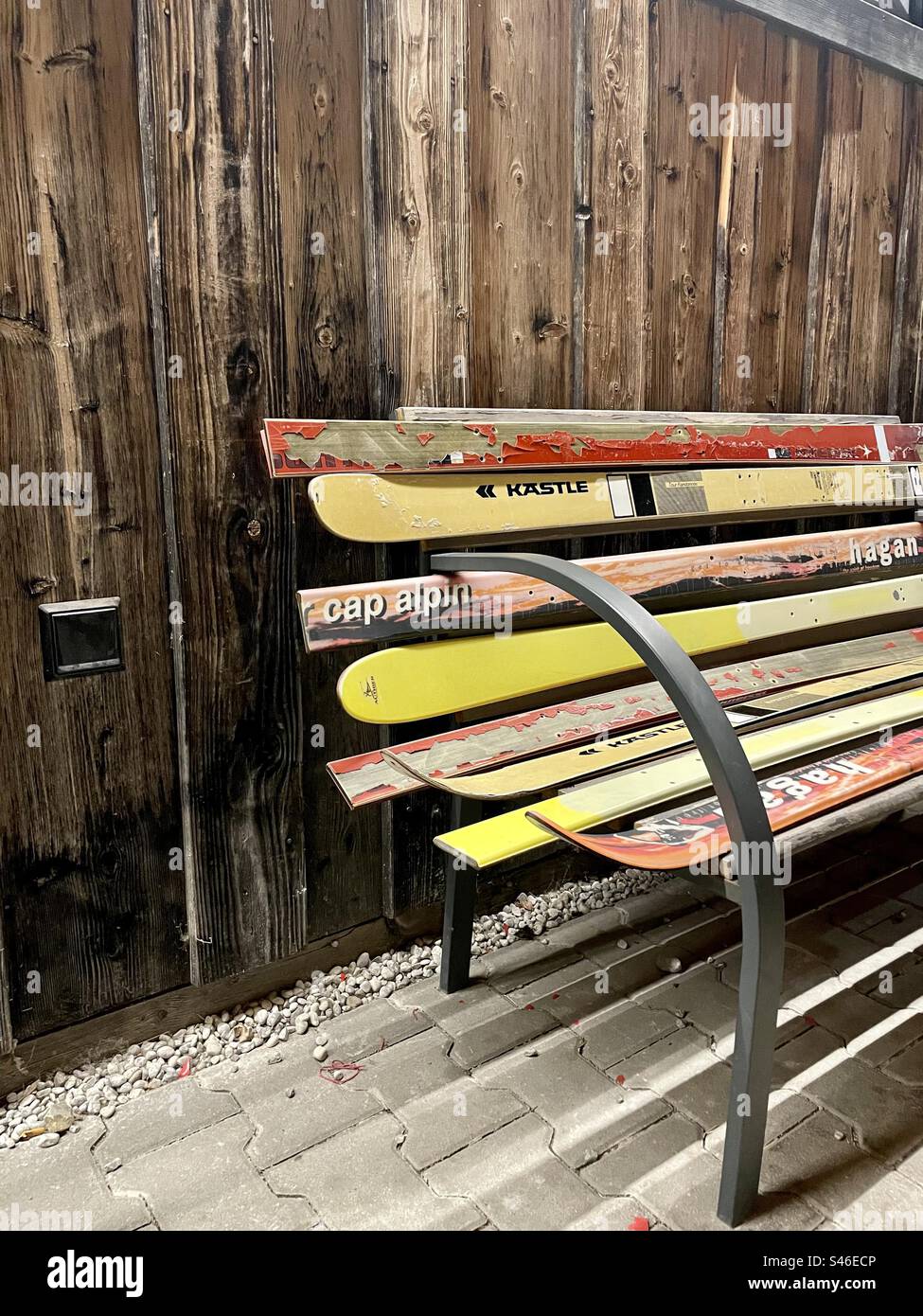 A vibrant bank creatively crafted from repurposed old skis. A colorful fusion of outdoor adventure and functional design. - Smartphone Captured Stock Image