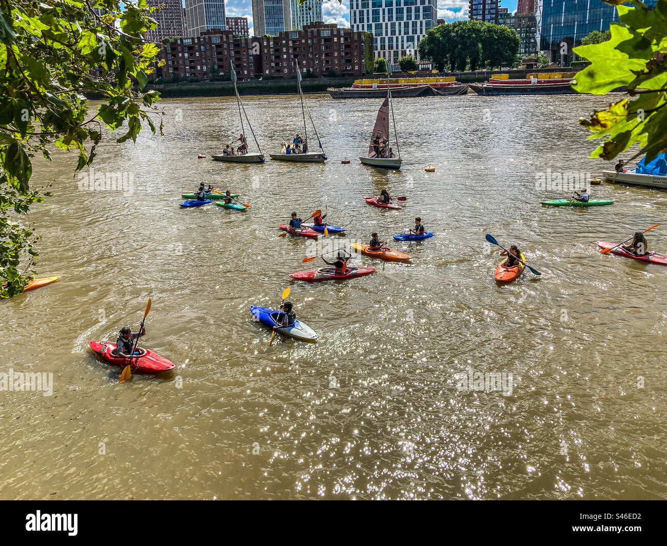Kids learning to use a canoe, in the River Thames at the Chelsea Embankment, London - Smartphone Captured Stock Image