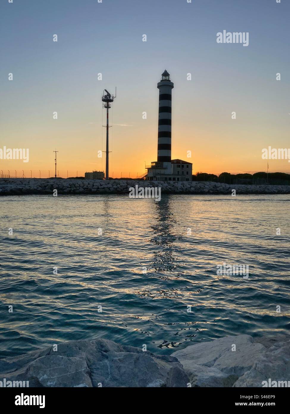 Sunset sky behind a lighthouse and sea - Smartphone Captured Stock Image
