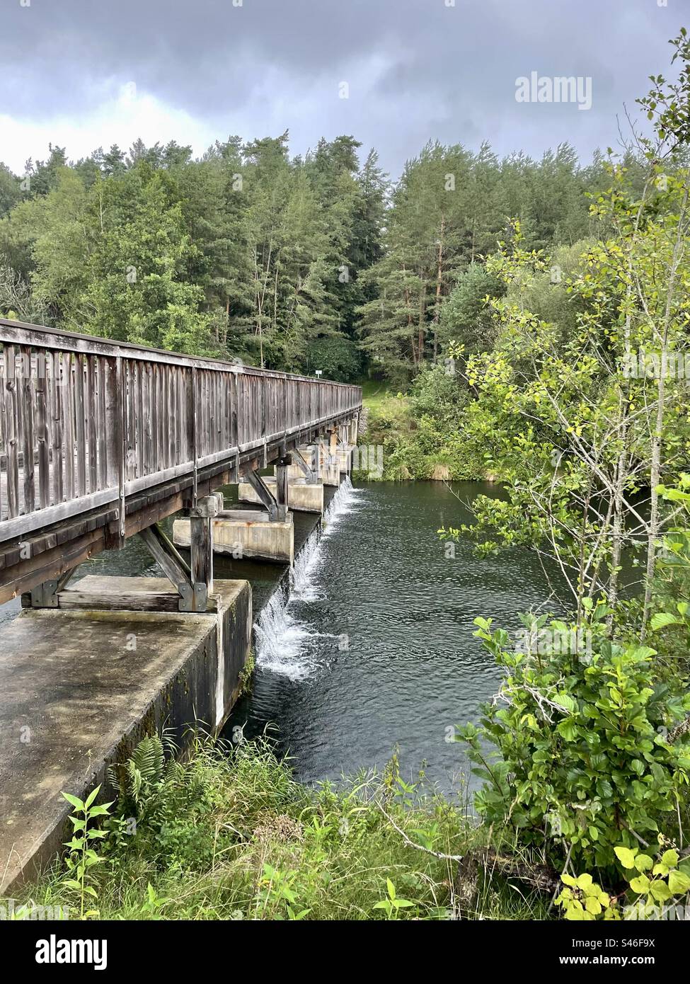 Located in the extension of Germany's famous Brombachsee dam, there is a small waterfall called Staustufe Mandlesweiher and a bridge over it. - Smartphone Captured Stock Image