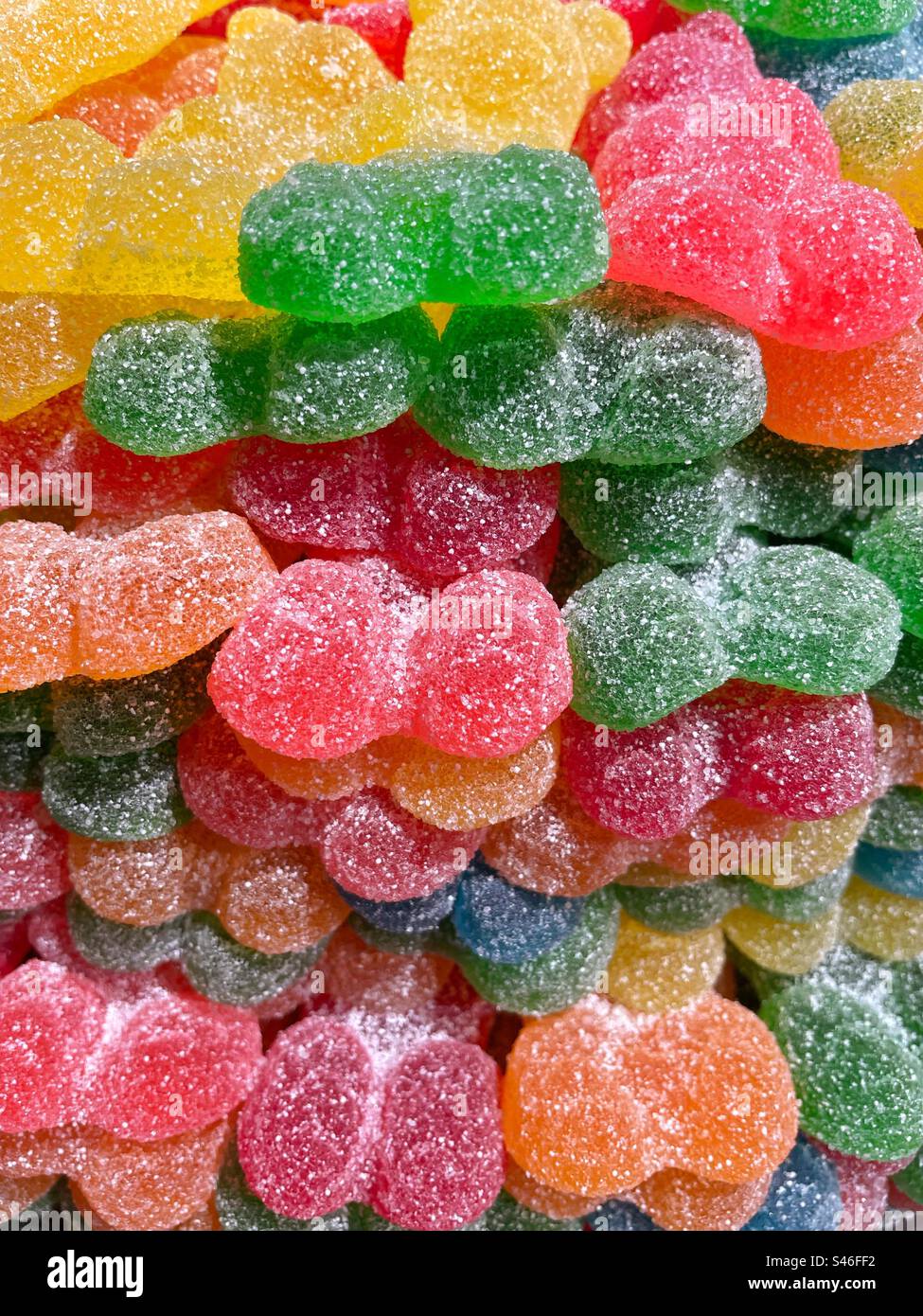 A stack of jelly bear sweets, all dusted with sugar. - Smartphone Captured Stock Image