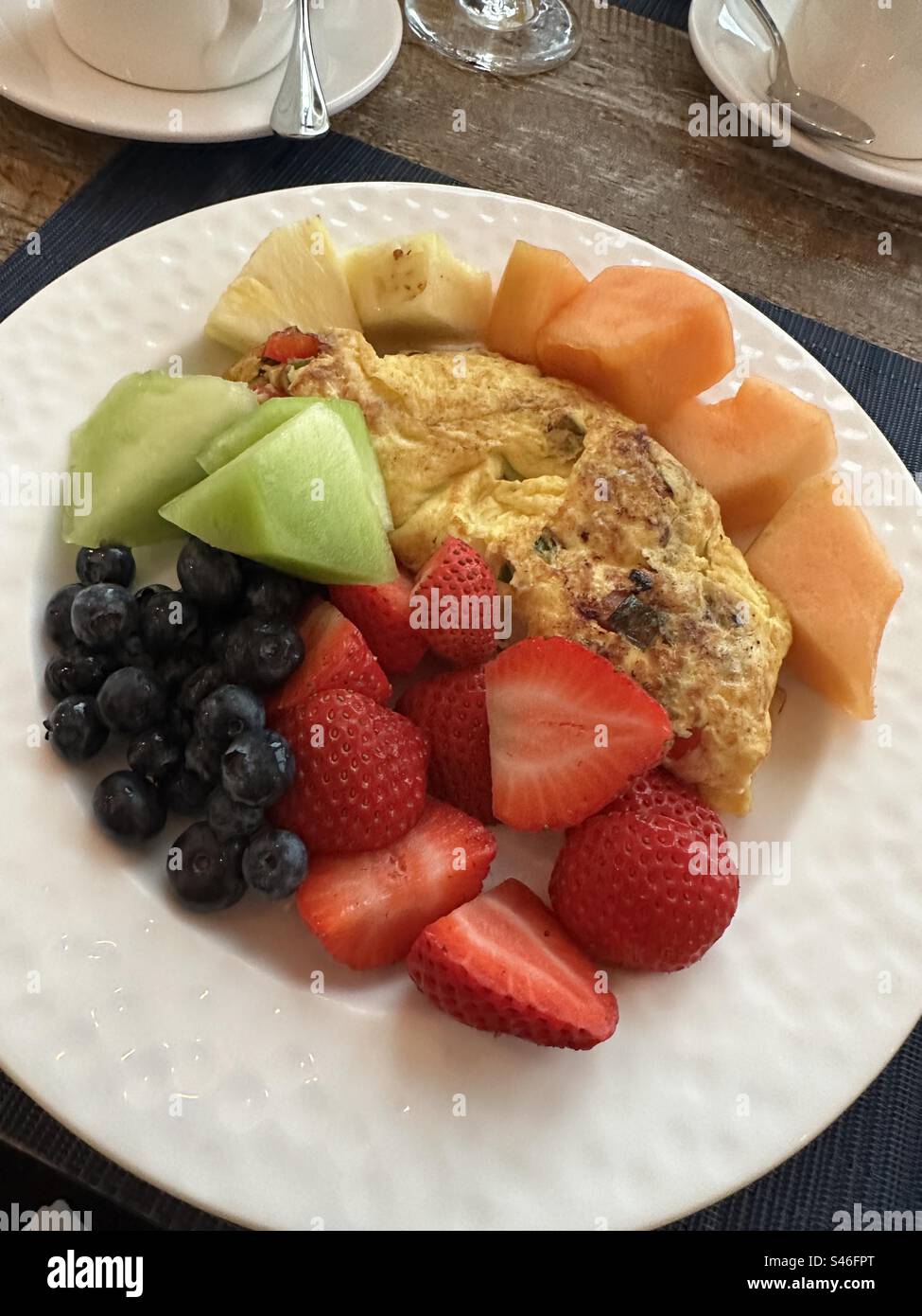 Healthy breakfast of vegetable omelet with assorted fresh fruit Stock