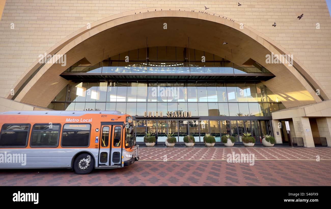 LOS ANGELES, CA, DEC 2022: LA Metro bus passing in front of entrance to Union Station in Downtown, seen from Patsaouras Transit Plaza, departure and arrival point for buses and coaches - Smartphone Captured Stock Image