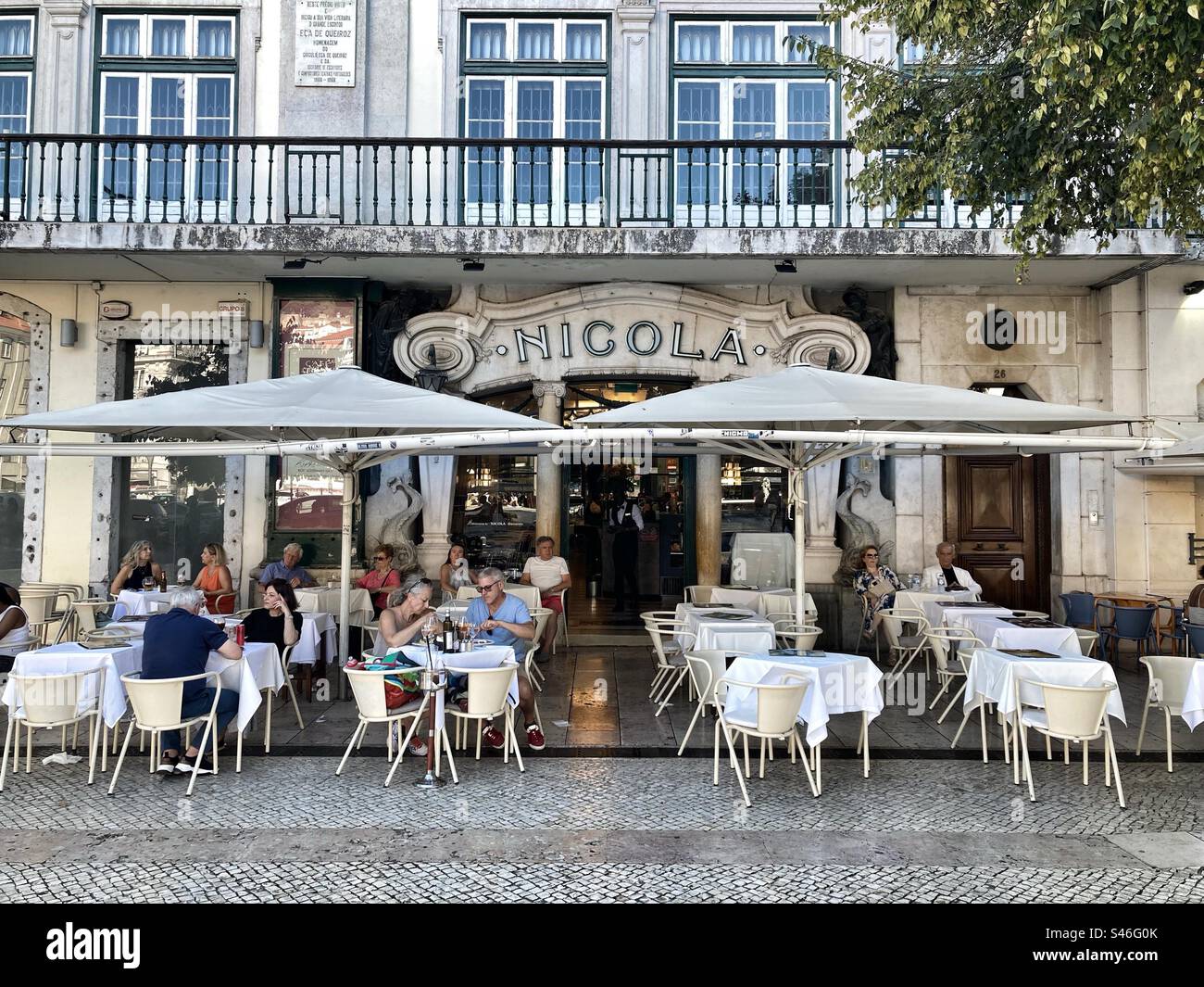 Café Nicola and esplanade with tourists eating and drinking, located in Lisbon downtown, Praça D.Pedro. Pombaline area. - Smartphone Captured Stock Image