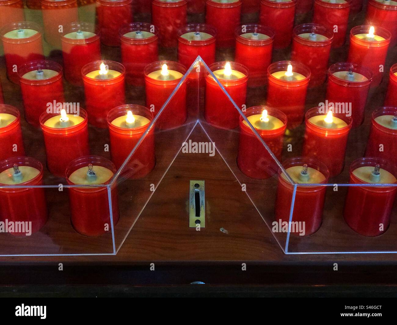 Coin-operated votive candle rack inside the Igreja de São Domingos, Viana do Castelo, Portugal, 2022 - Smartphone Captured Stock Image