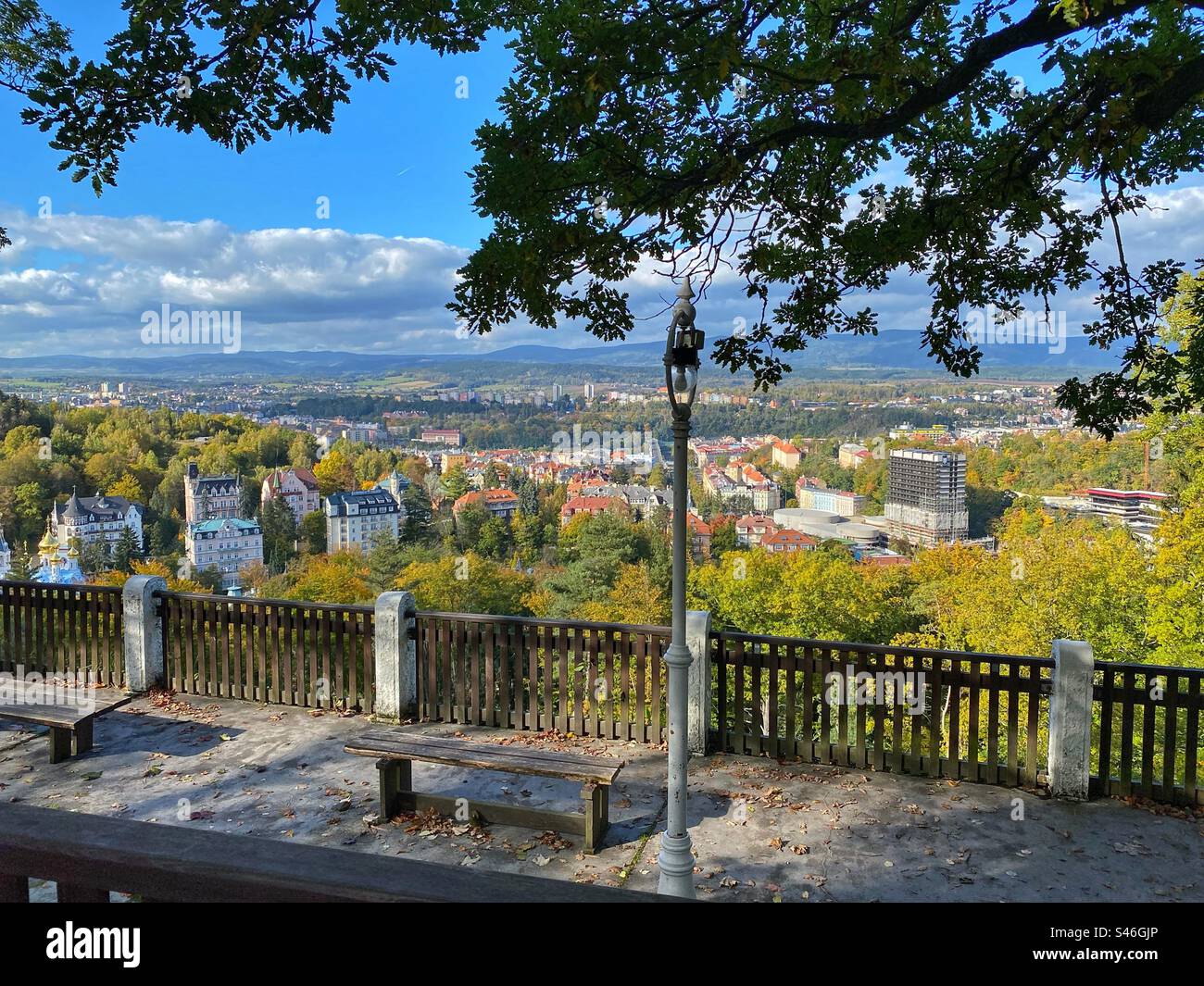 High-angle view at Karlovy Vary surrounded by forests with bench and lantern, Czech Republic. - Smartphone Captured Stock Image