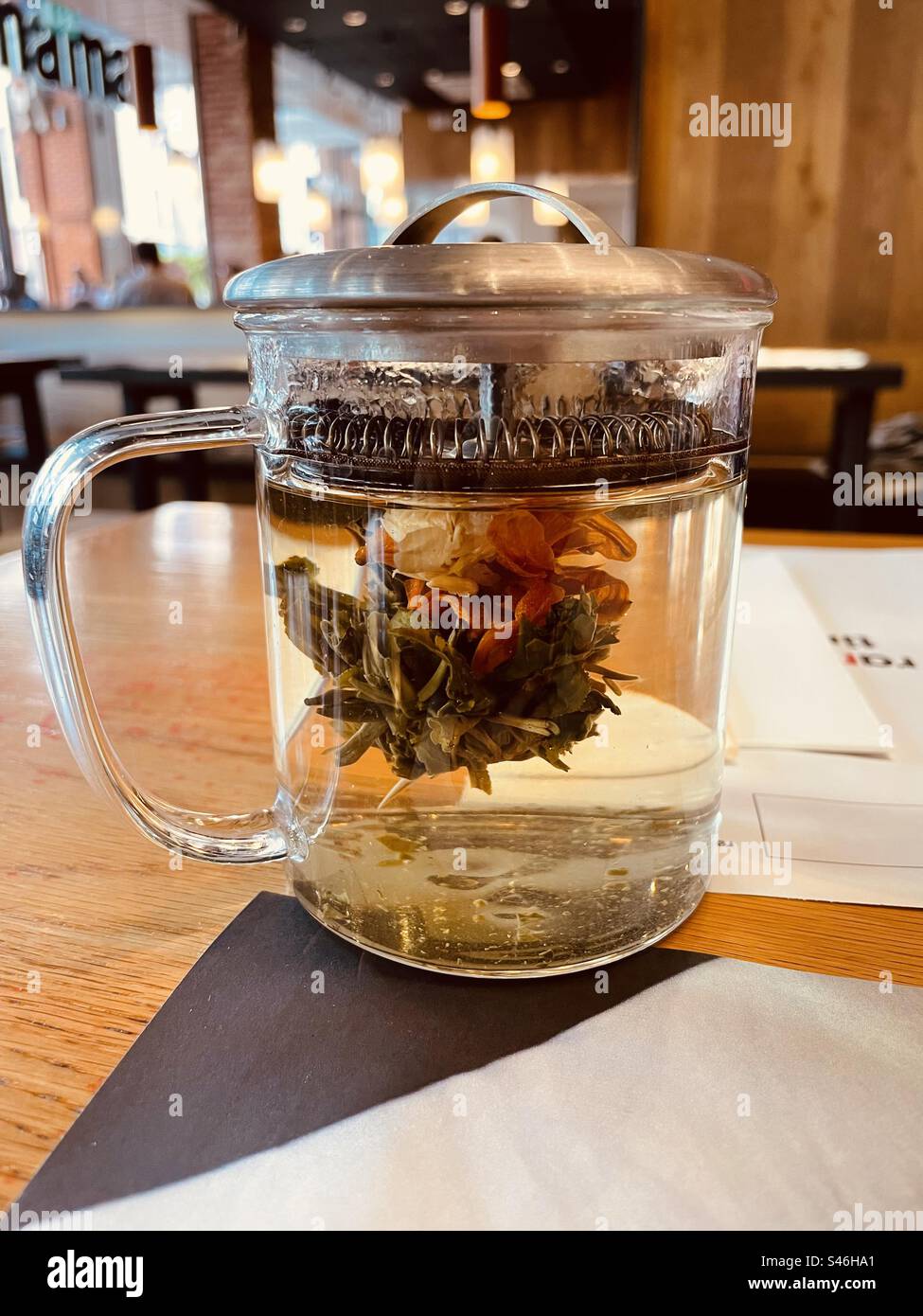 A pot of flowering jasmine tea on a restaurant table, at Wagamama