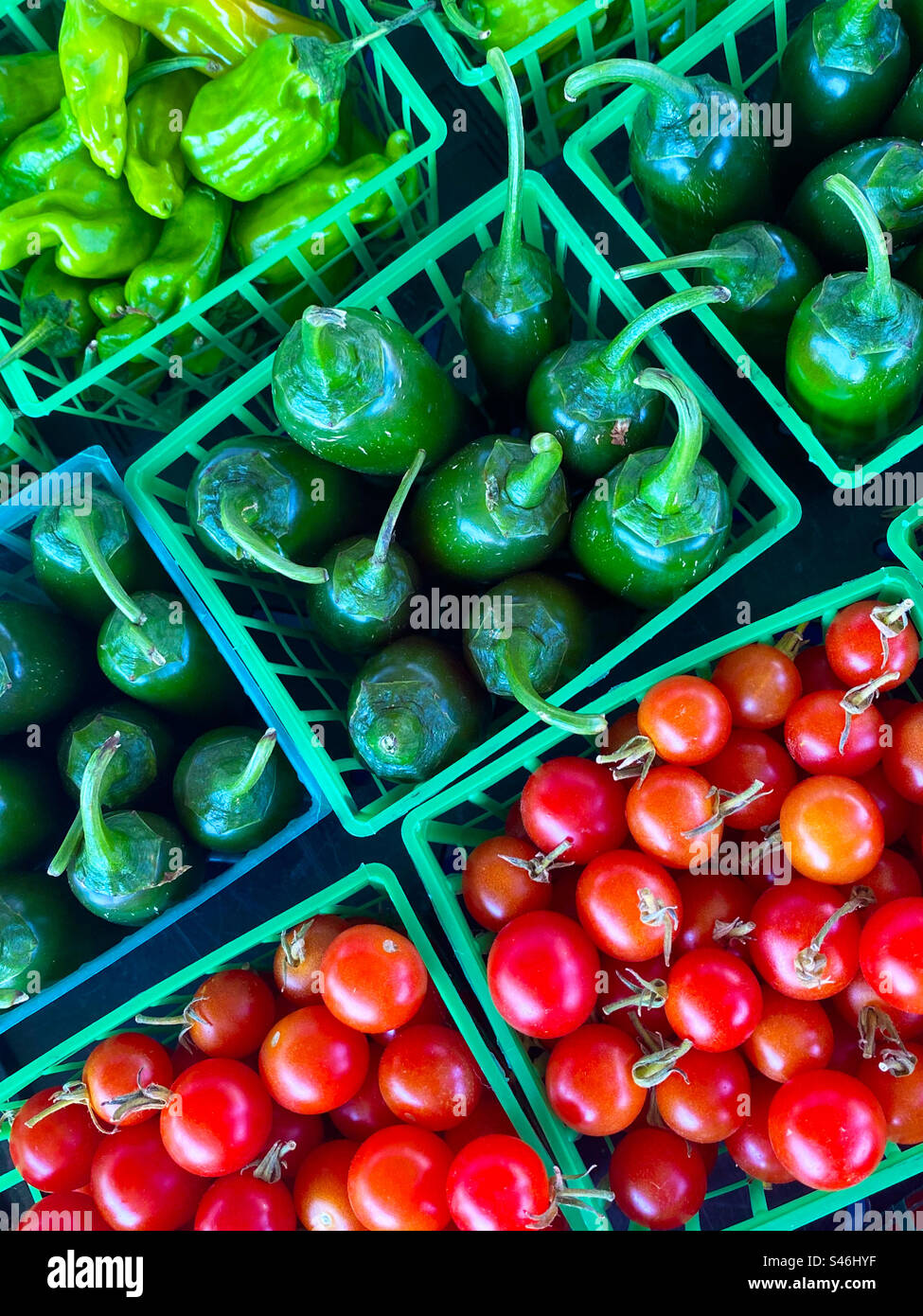 Containers of peppers and cherry tomatoes at farmers market Stock Photo