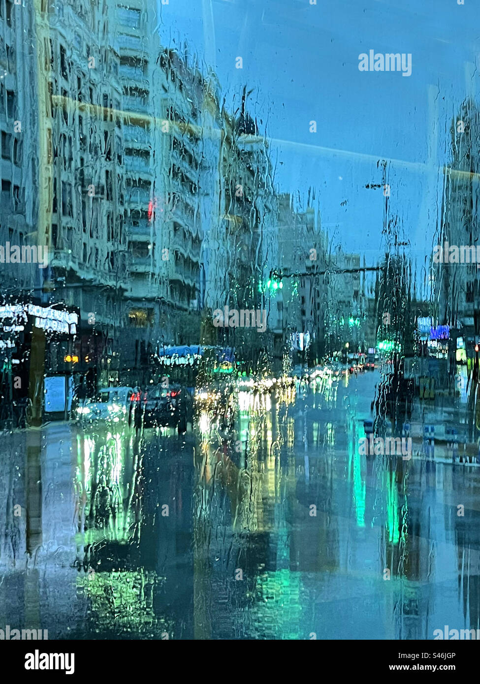 View through a wet glass. Gran Via street, Madrid, Spain. - Smartphone Captured Stock Image