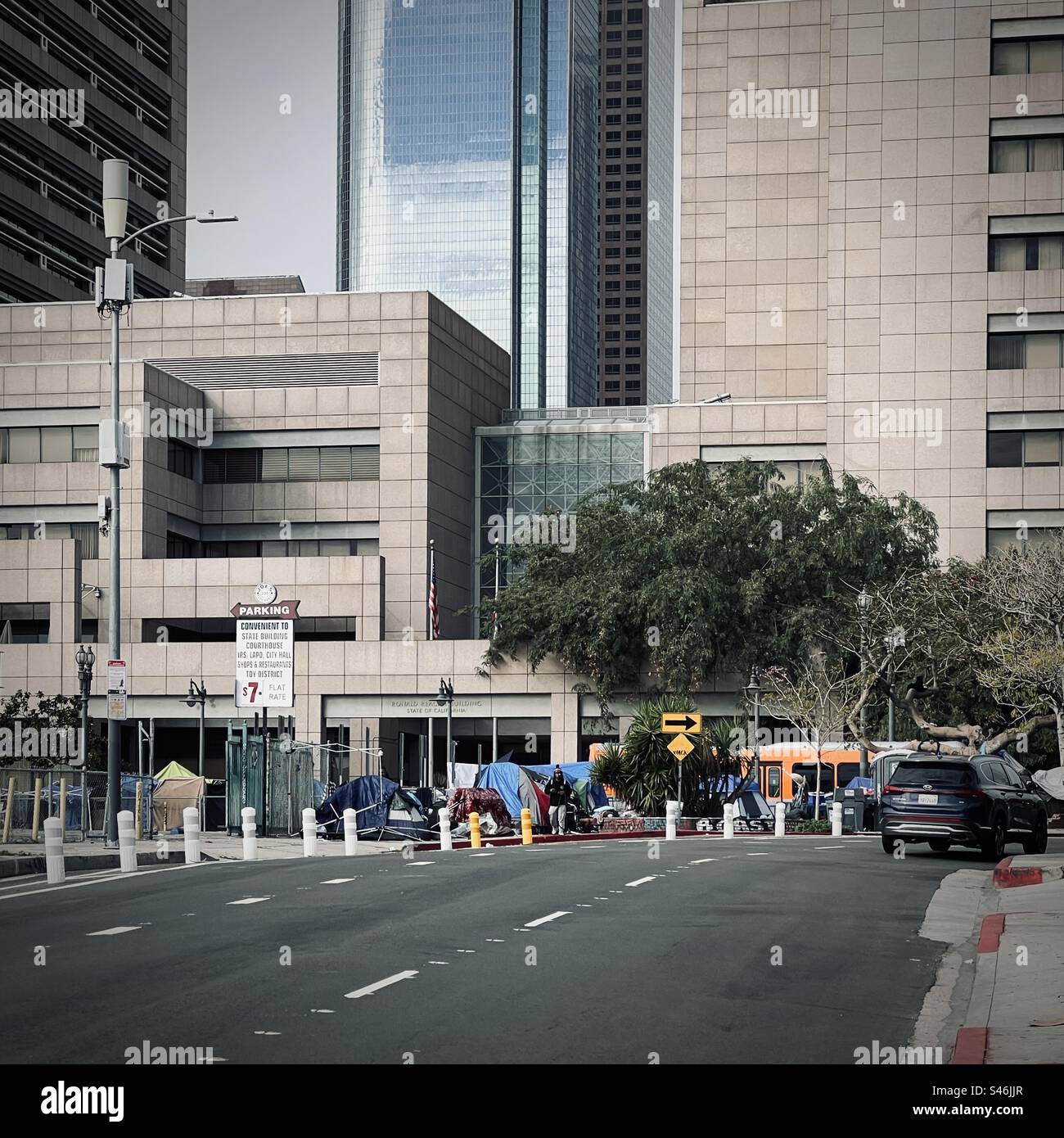 LOS ANGELES, CA, JAN 2023: homeless encampment with multiple tents set up on a busy corner near businesses in Downtown - Smartphone Captured Stock Image