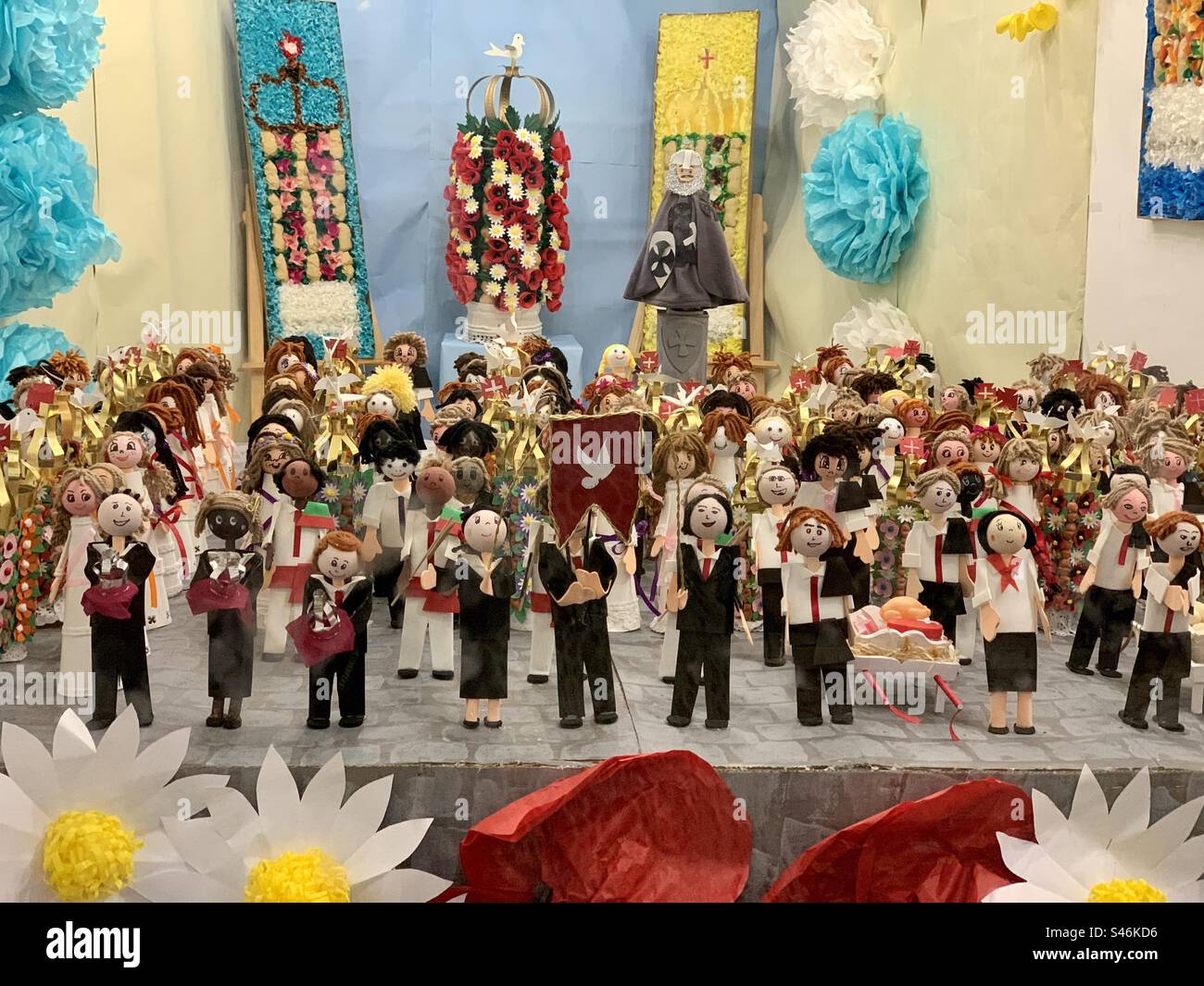 Shop display featuring tiny figures that represent participants in the Cortejo dos Tabuleiros - Smartphone Captured Stock Image