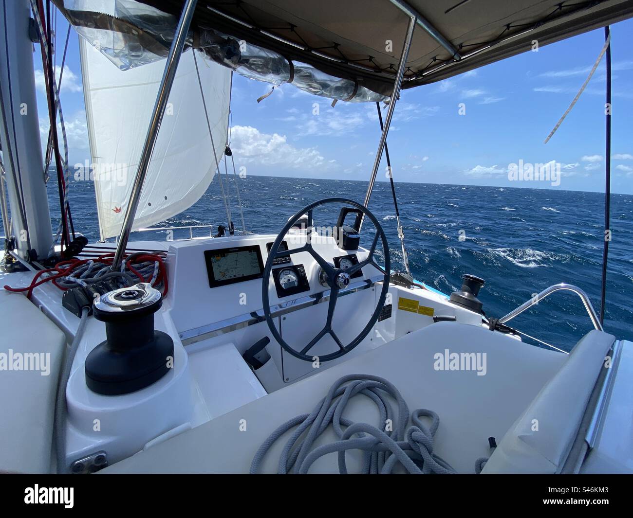 POV from the helm of a 50’ catamaran sailing on the ocean - Smartphone Captured Stock Image