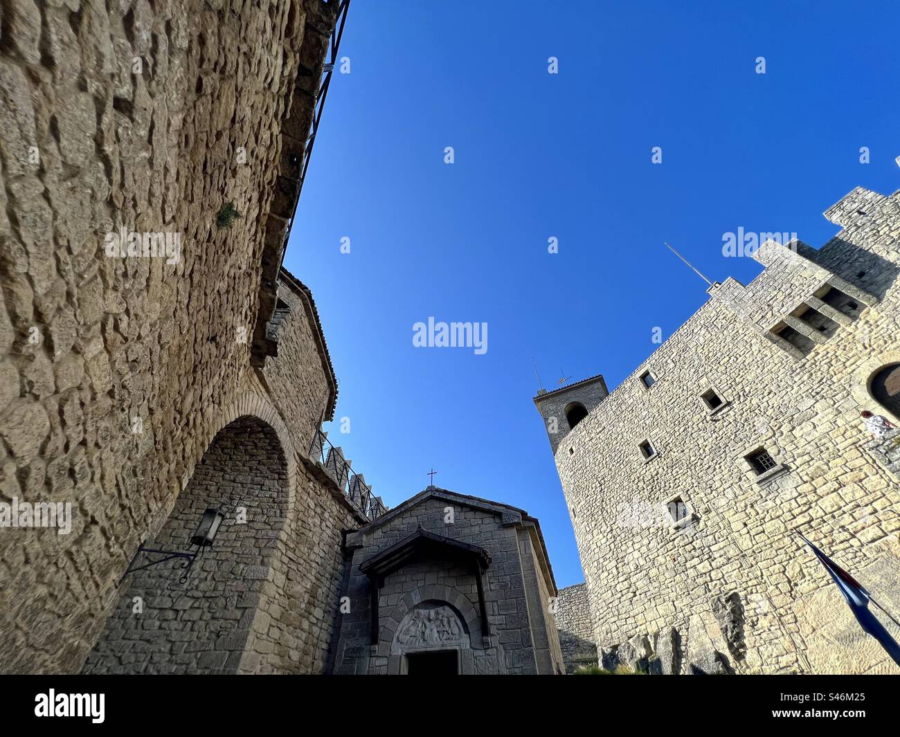 Chiesa asanta Barbara nestled in between buildings of the Guaita fortress in the City of San Marino - Smartphone Captured Stock Image