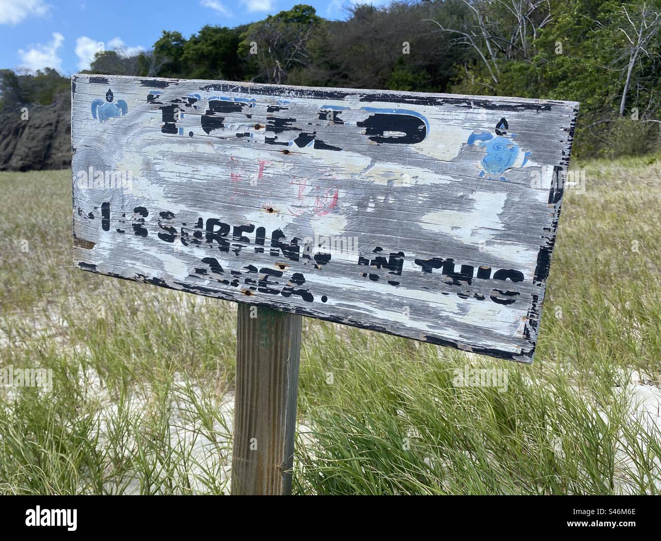 Beach with No kite surfing in the area sign, old worn out and hard to read. - Smartphone Captured Stock Image