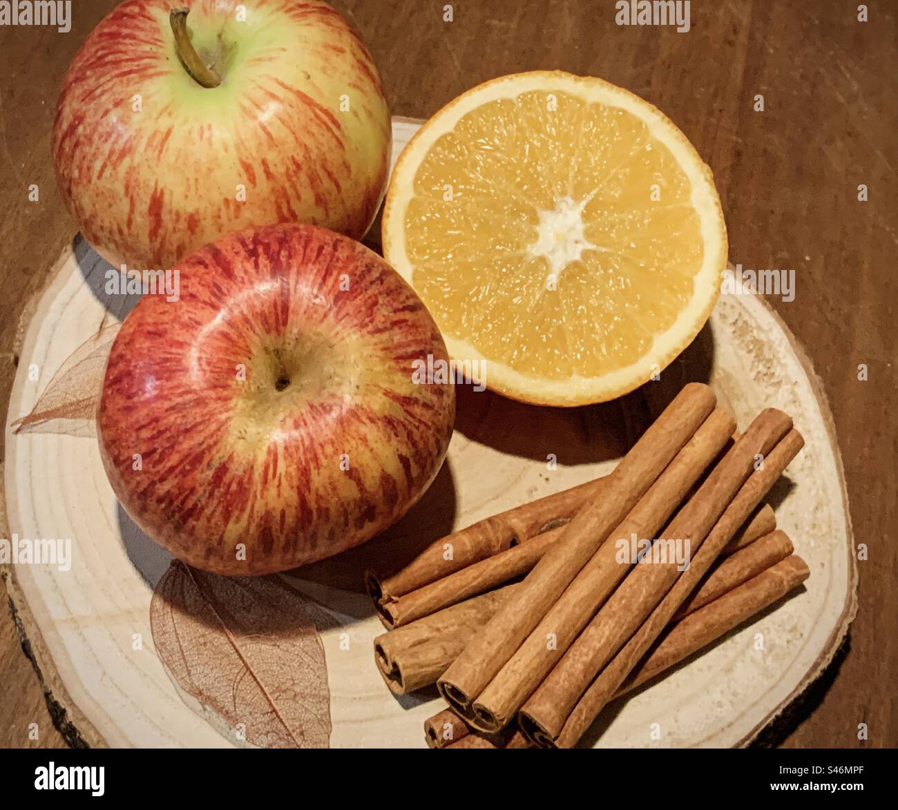 Apples, orange & cinnamon on a wood platter - Smartphone Captured Stock Image