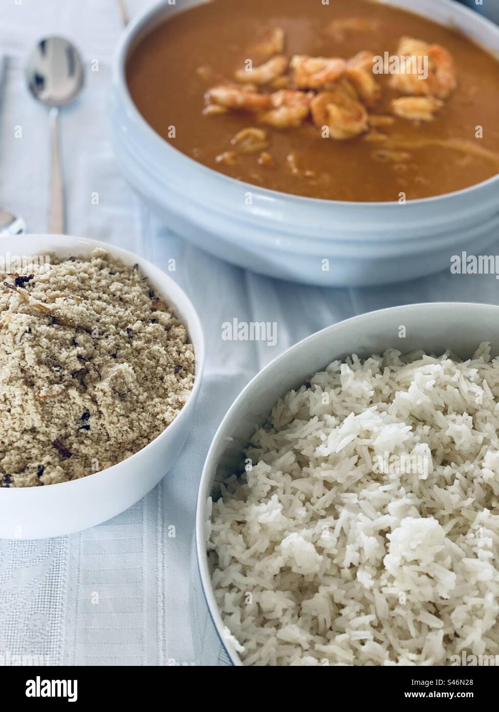 A Brazilian dish called moqueca de camarão with farofa and rice. Cascais, Portugal, 2023. - Smartphone Captured Stock Image