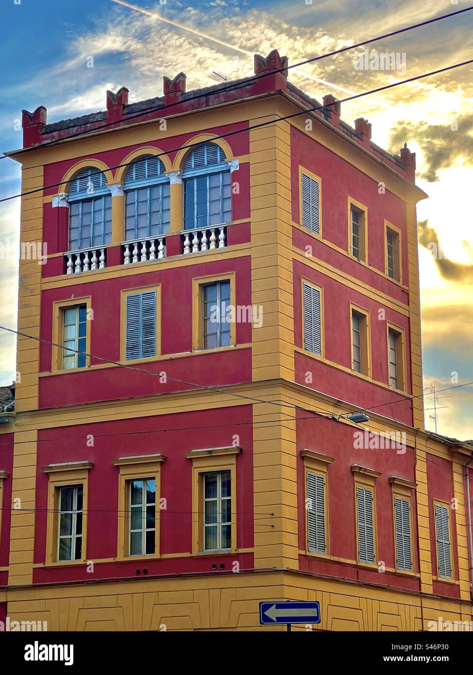 Vibrant red and yellow shades on a portion of the Military Academy of Modena - Smartphone Captured Stock Image