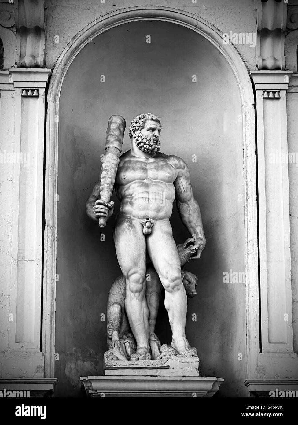 Statue of Hercules with a club and Cerberus, a multi-headed dog, in a portal next to the entrance of Palazzo Ducale in Modena, Italy Stock Photo