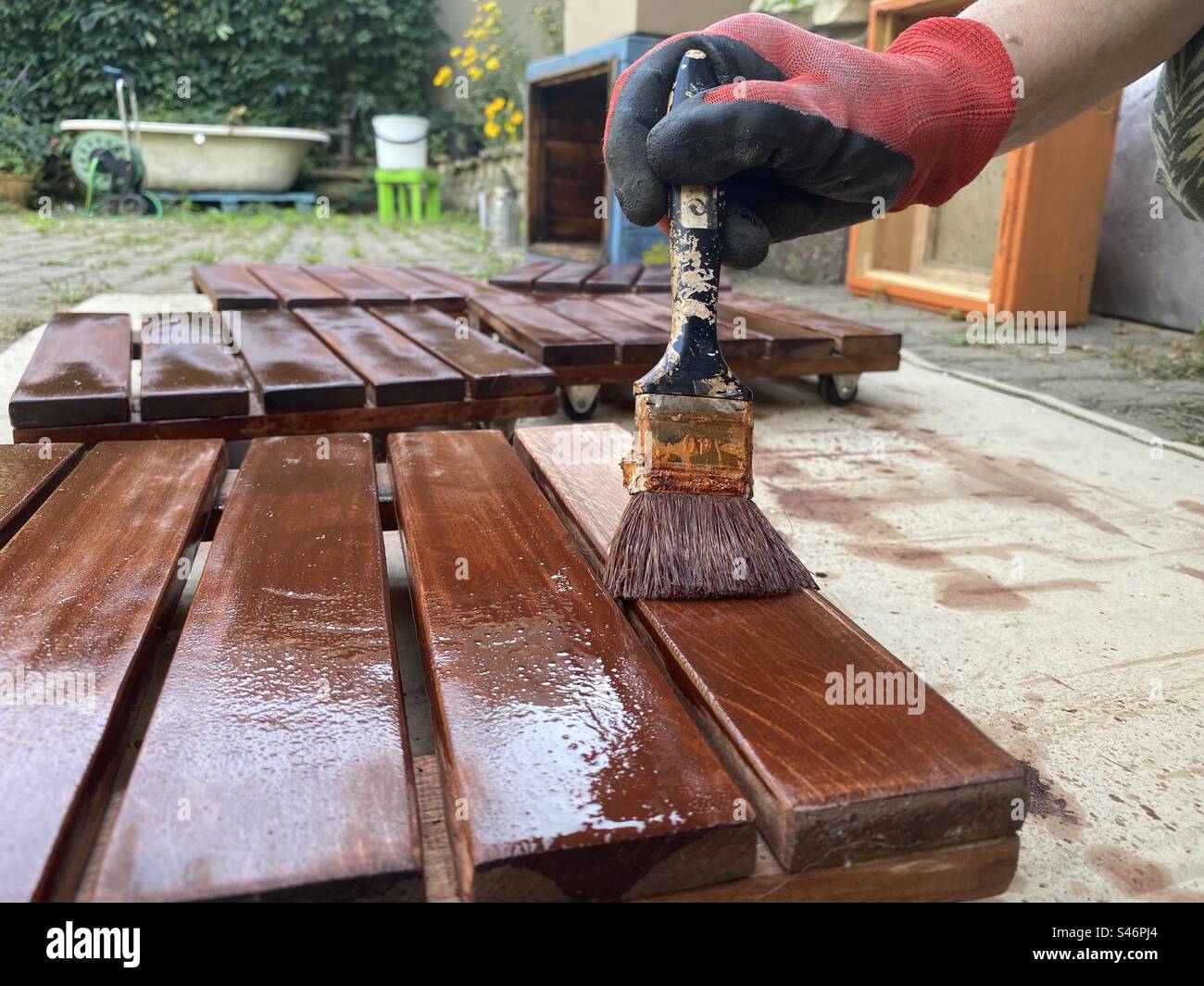 painting boards with brown paint - Smartphone Captured Stock Image