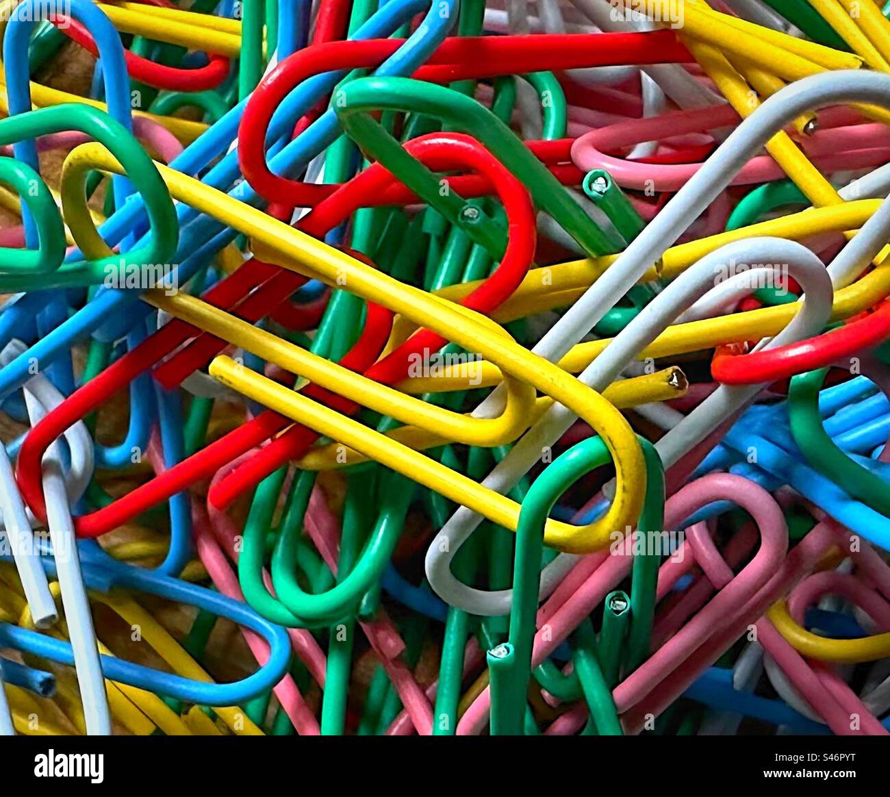 ‘Paper Clip Puzzle’ a close up of a large bundle of multicoloured paperclips in a pile. Stock Photo
