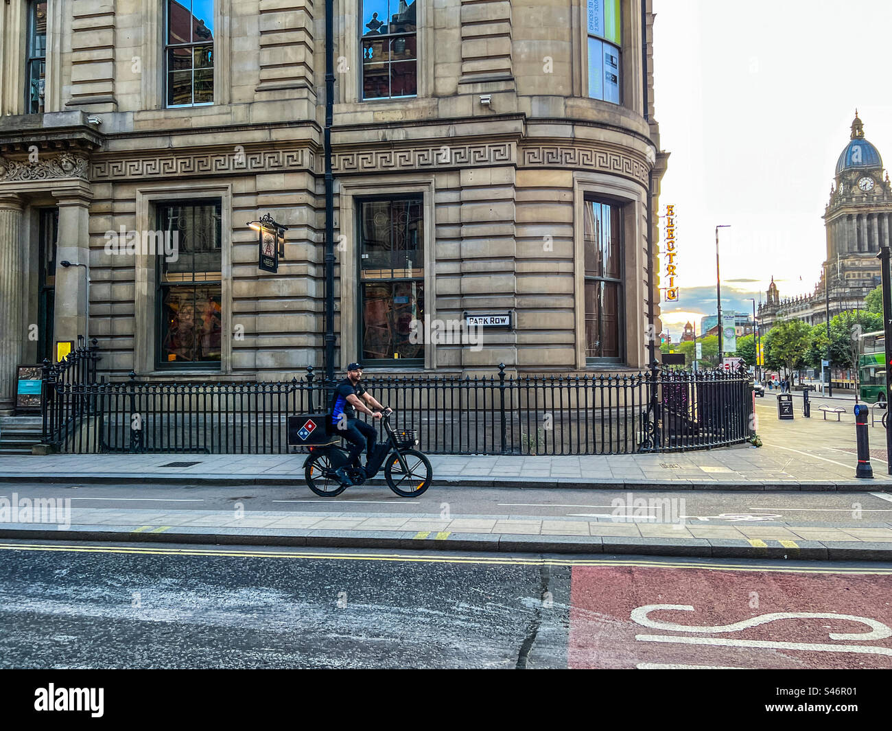 Dominoes pizza delivery cyclist in Leeds City Centre - Smartphone Captured Stock Image