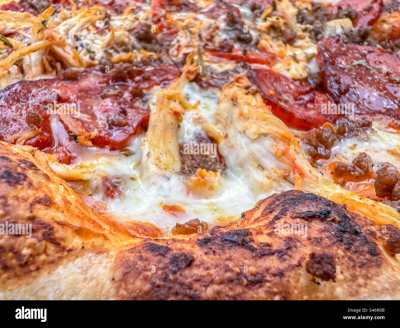 Meat feast with pepperoni chorizo and chicken pizza - Smartphone Captured Stock Image