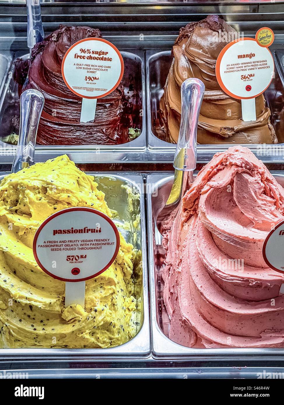 High angle view of a range of colorful, delicious gelato and sorbet on display inside shop for sale. Retail. - Smartphone Captured Stock Image