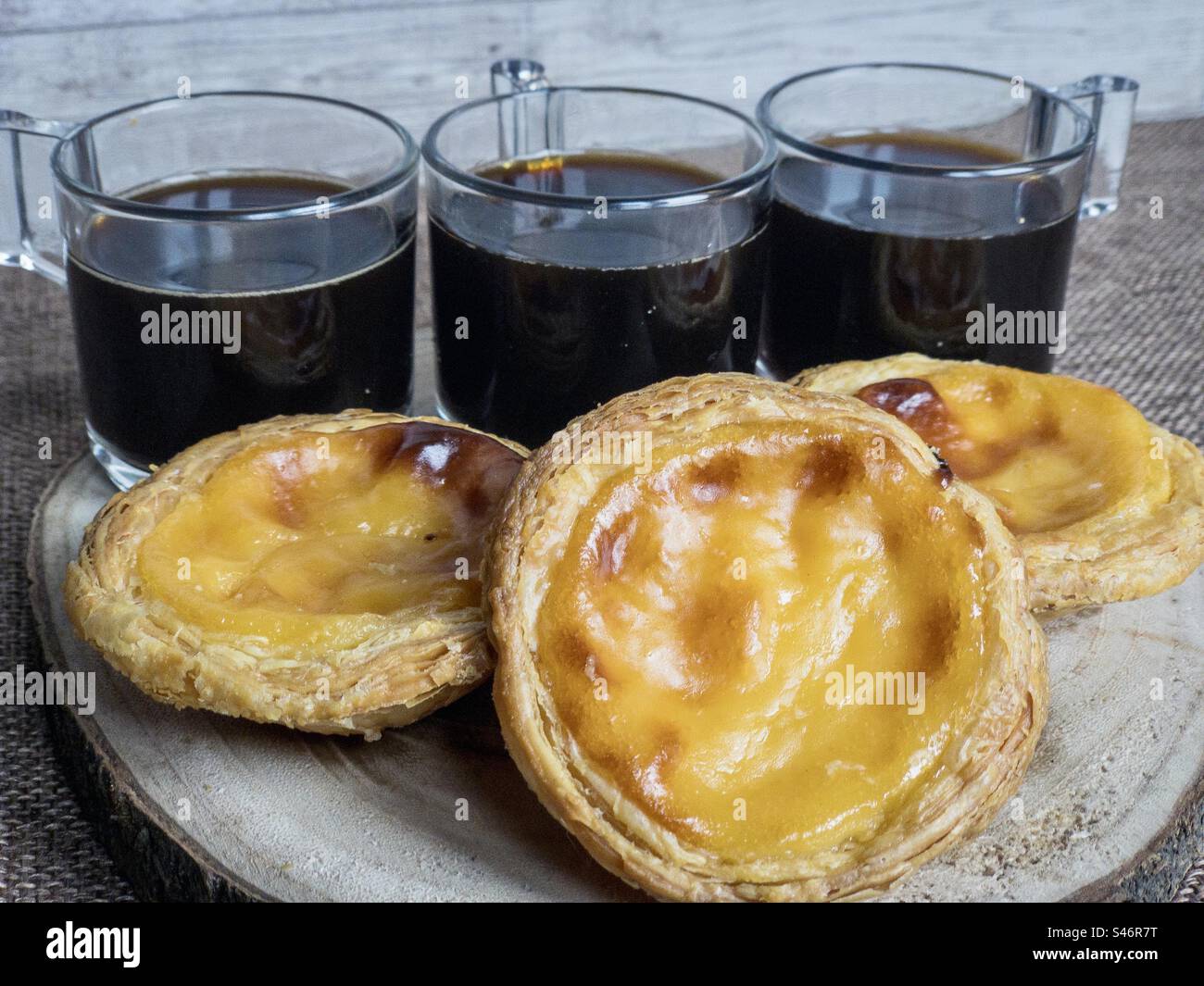 Black coffee and pastéis de nata. - Smartphone Captured Stock Image