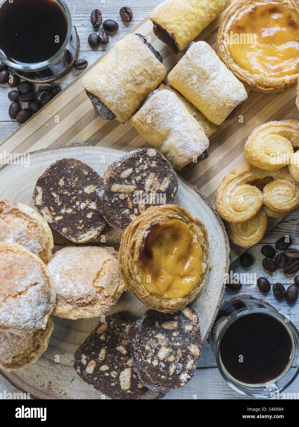 A selection of Portuguese pastries and black coffee - Smartphone Captured Stock Image