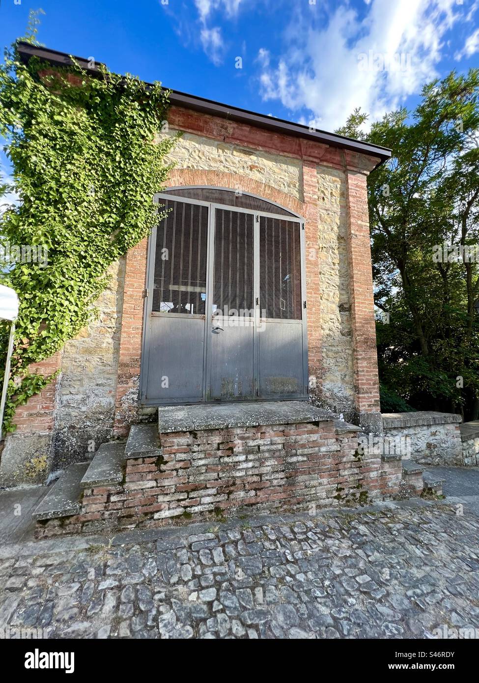 Old building houses bells in the village of Monfestino, Serramazzoni, Italy - Smartphone Captured Stock Image
