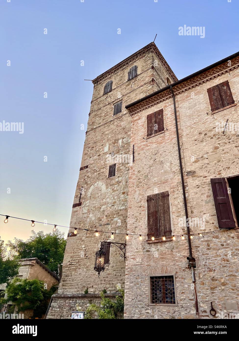 Lantern and lights glowing at dusk at Castello di Montegibbio in Sassuolo - Smartphone Captured Stock Image