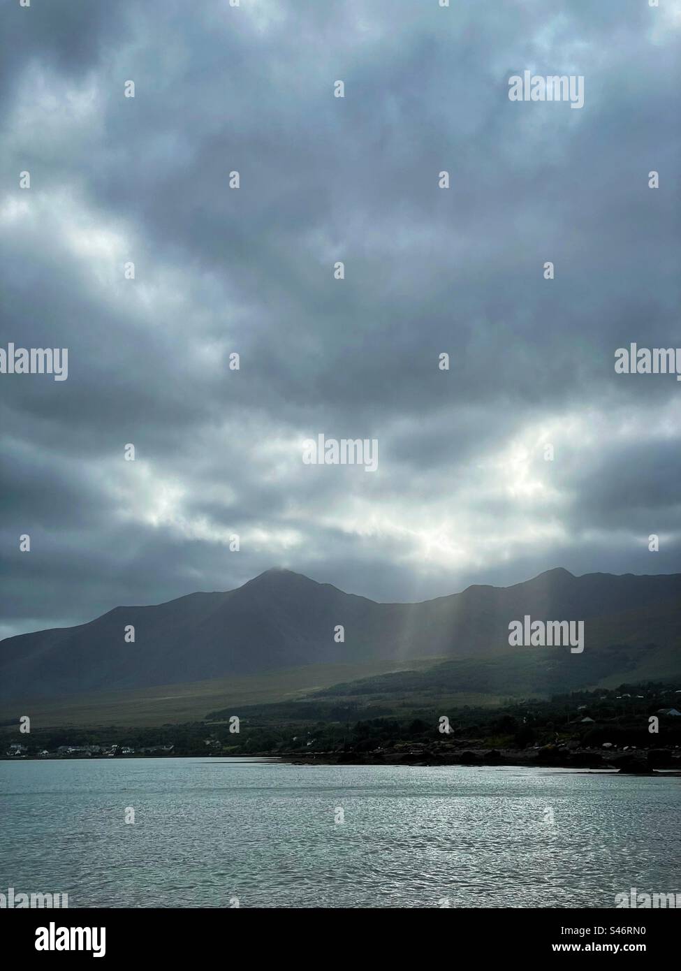 Shafts of light from stormy skies over Mount Brandon, County Kerry, Ireland. - Smartphone Captured Stock Image