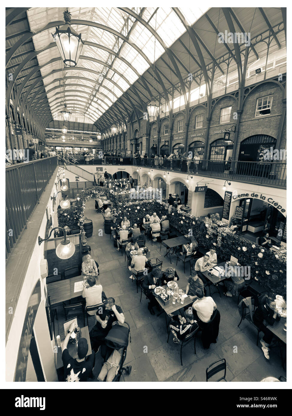 People enjoying themselves in Covent Garden in London UK - Smartphone Captured Stock Image