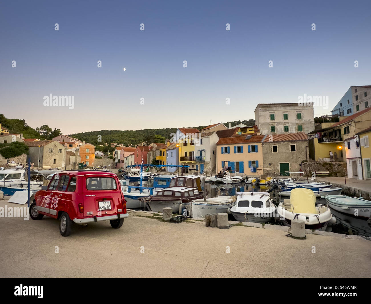 Veli Lošinj harbour with red car. - Smartphone Captured Stock Image