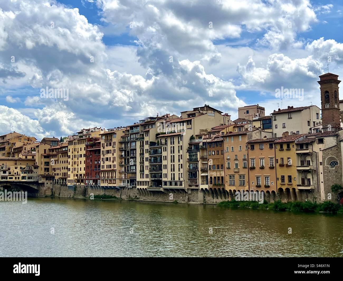 Buildings lining the banks of the Arno River leading up to Ponte Vecchio n Florence, Italy. - Smartphone Captured Stock Image