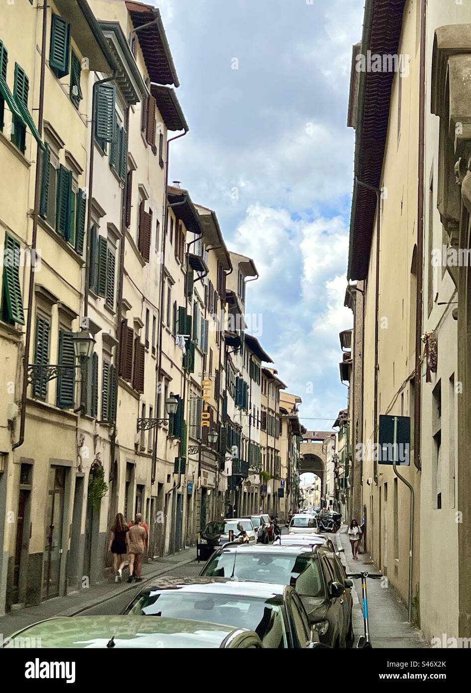 View on Borgo San Frediano street with the arched structure peeking out in background that had served as a historical gate to the city center of Florence. Stock Photo