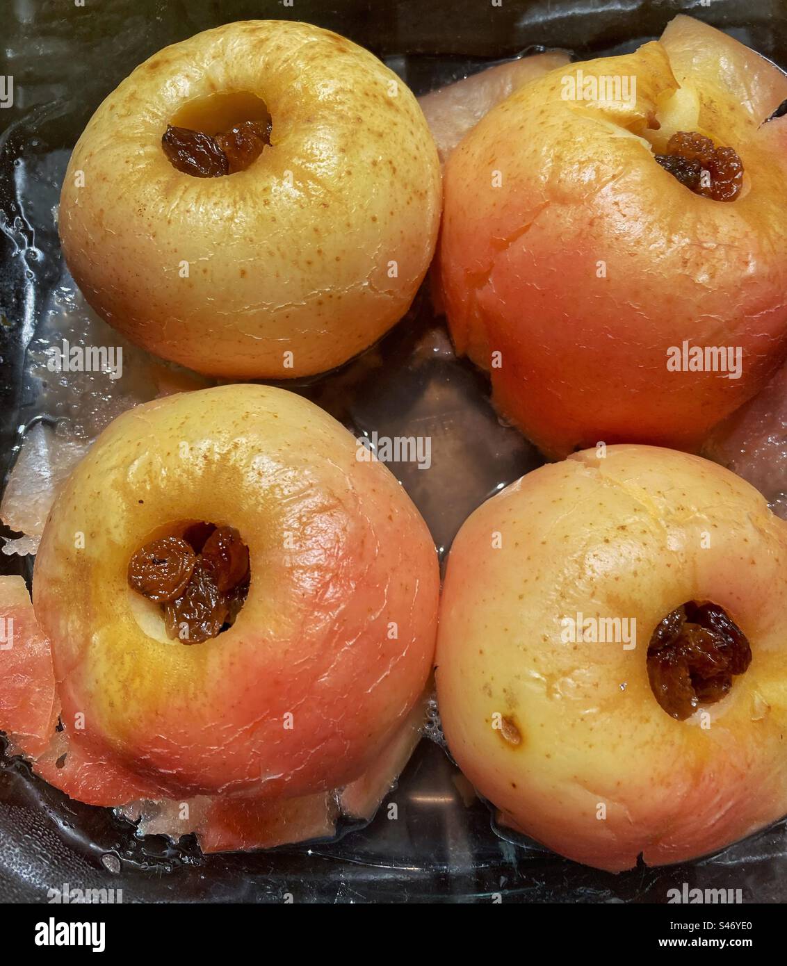 Baked apples stuffed with dried fruits in a baking tray - Smartphone Captured Stock Image