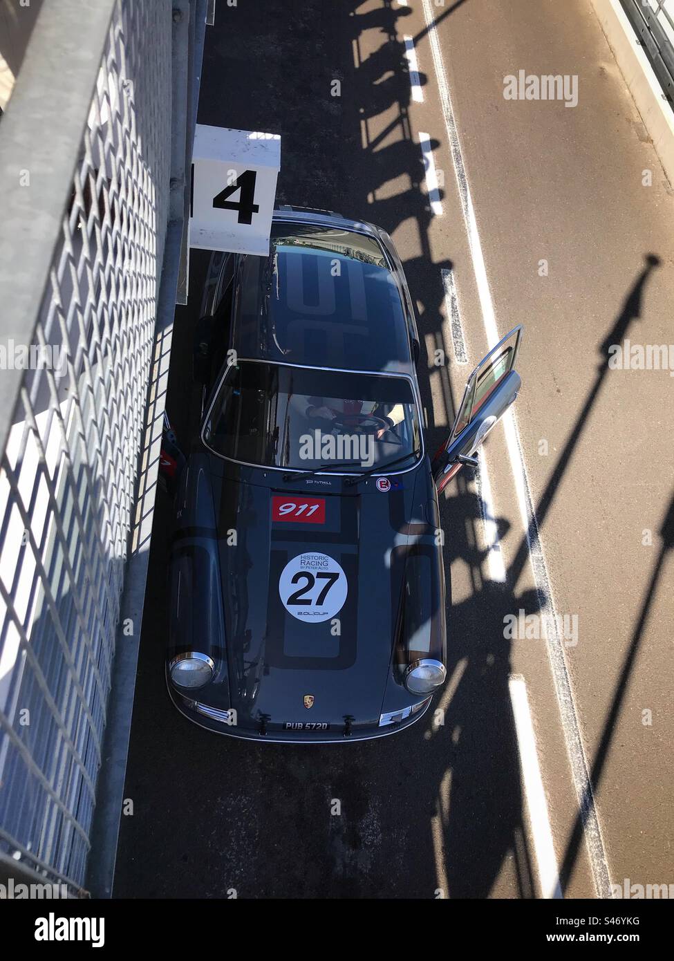 1960s grey Porsche 911 in the pit lane on a test day for the Revival Meeting at Goodwood motor racing circuit,Chichester, West Sussex, UK - Smartphone Captured Stock Image