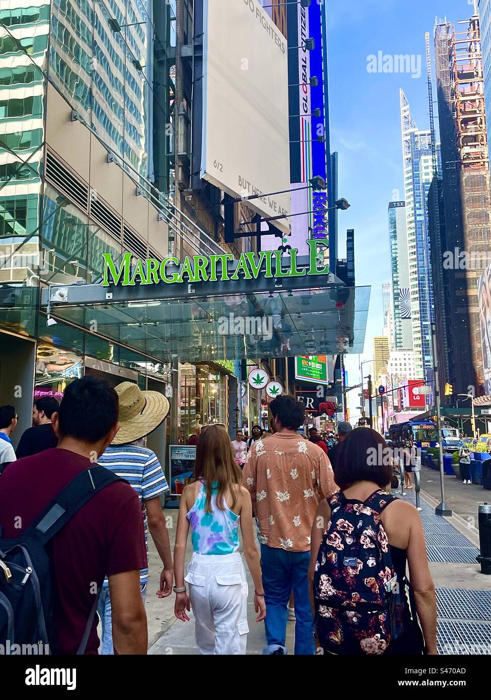 People walking by Margaritaville in Times Square, New York city, USA - Smartphone Captured Stock Image