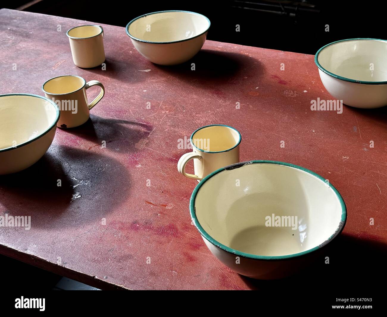 Enamel cups and bowls on table - Smartphone Captured Stock Image
