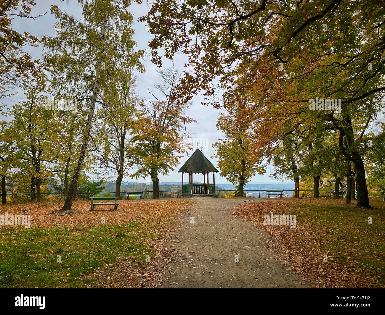 Three Crosses lookout surrounded by autumn colored trees on a hill in Karlovy Vary, Czech Republic. - Smartphone Captured Stock Image