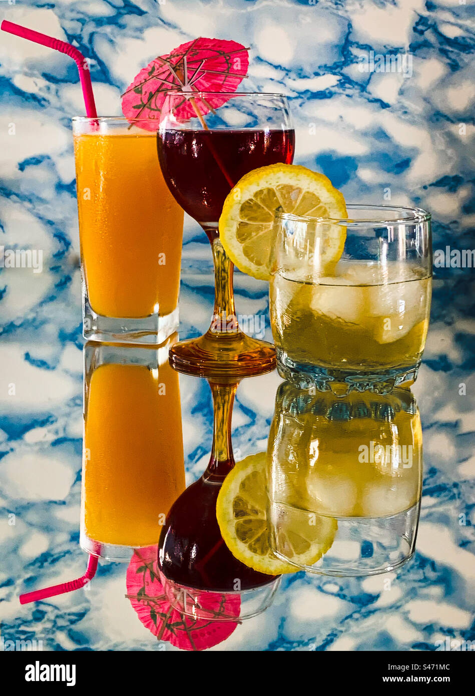 A selection of alcoholic drinks on a reflective surface Stock Photo