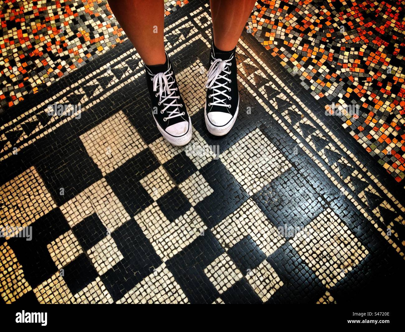 Black and white shoes on a black and white mosaic floor at the Natural