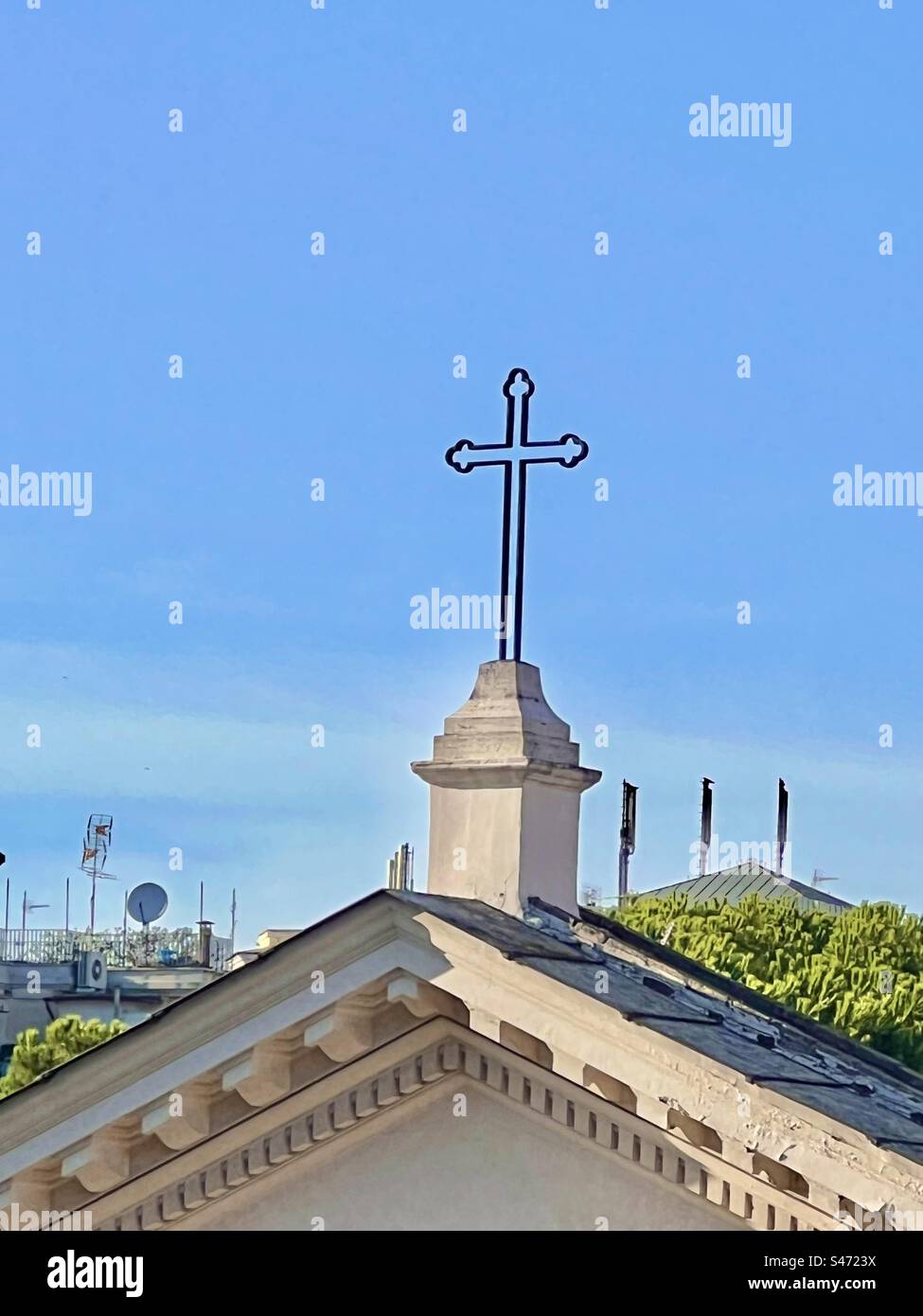 The roofline and cross on top of Basilica of San Clemente in the Celio district of Rome. Stock Photo