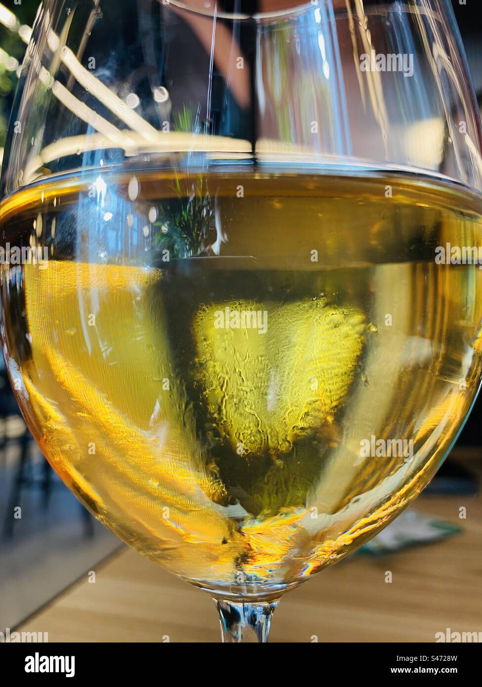 a glass of golden drink zoom in Stock Photo